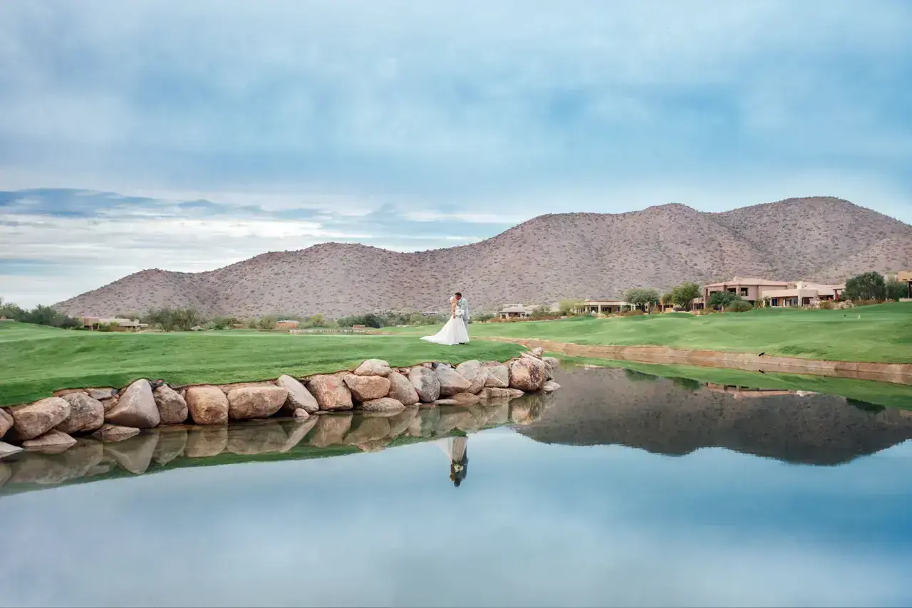 Bride and groom portrait outdoors at Ancala Country Club with lush golf course and mountain views