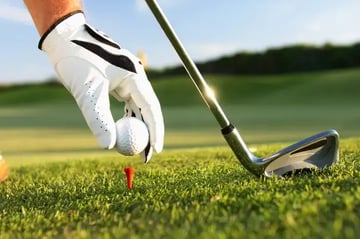 Golfer Placing Ball on Tee